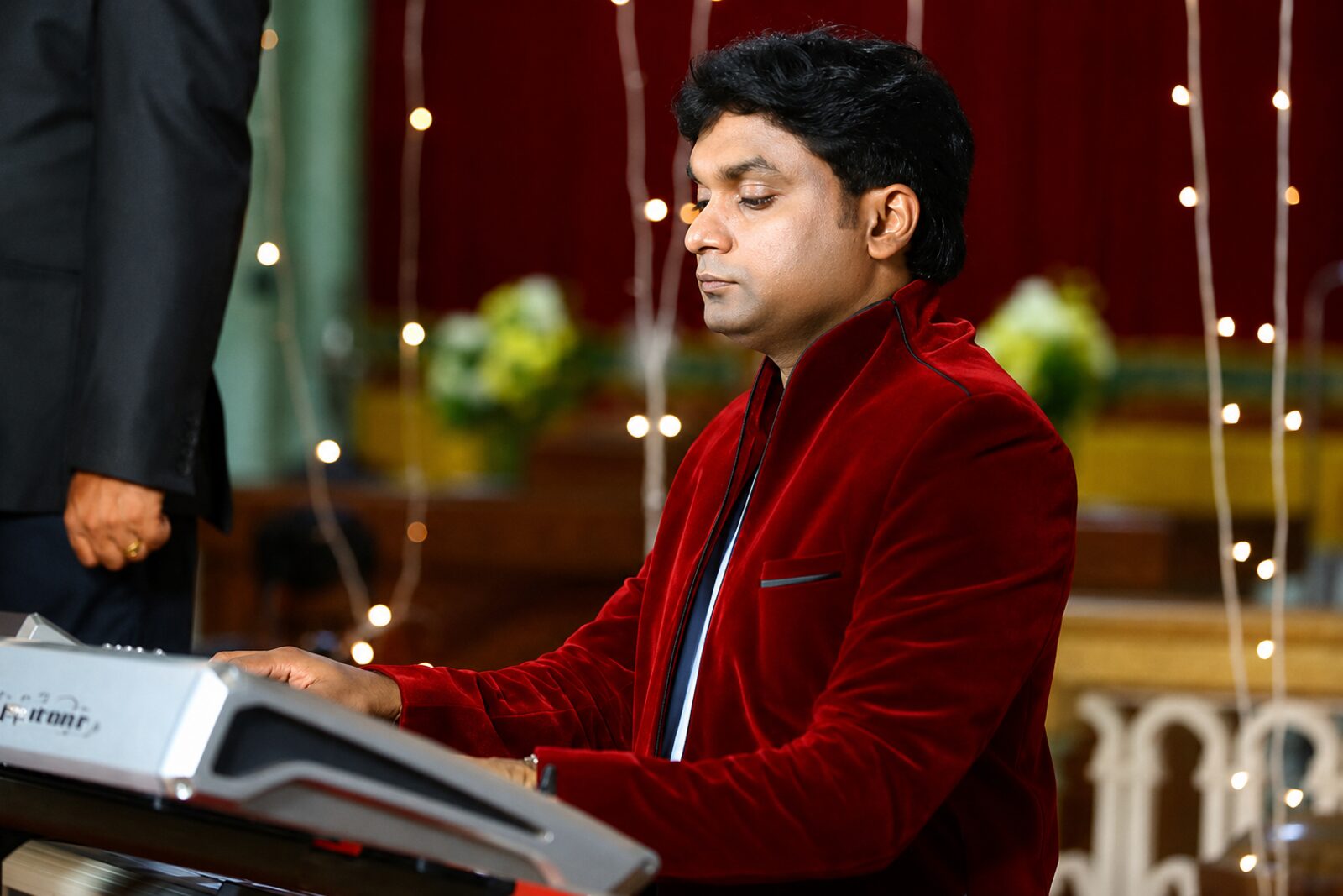 Anil Cheriyan singing and playing at a performance