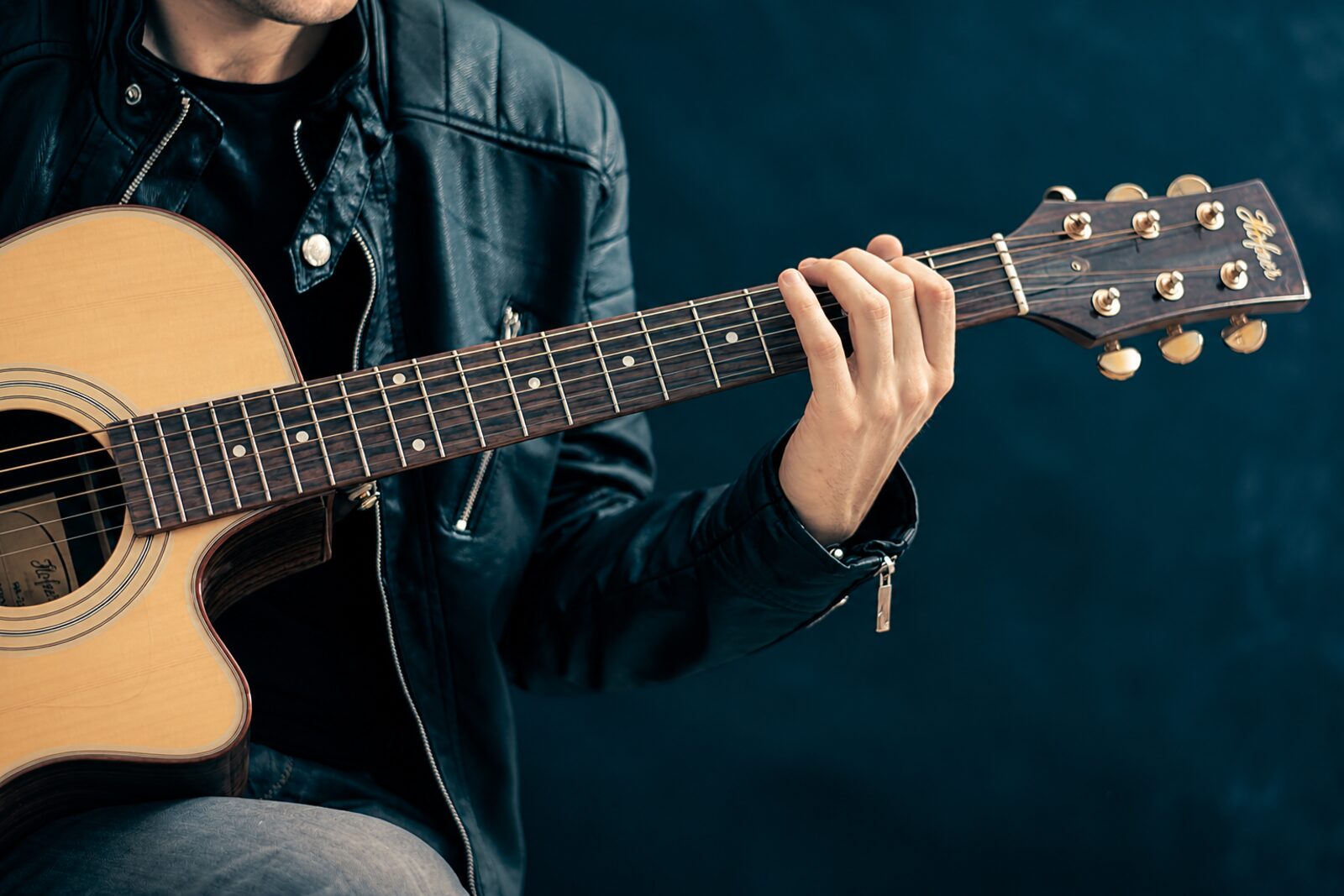 A student playing acoustic guitar